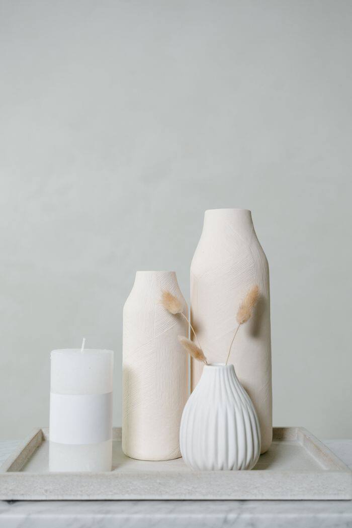 Candle and ceramic vases on a tray